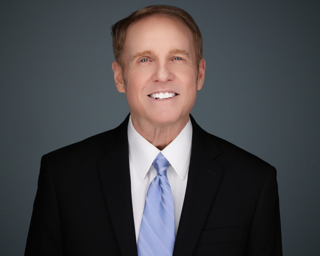 A professional headshot of an executive